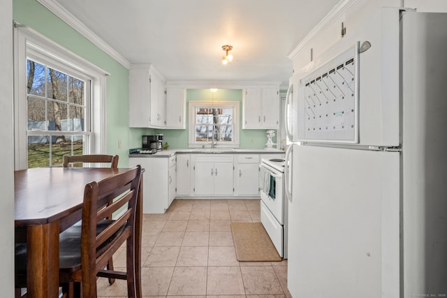 kitchen featuring white cabinets, white appliances, ornamental molding, sink, and light tile floors