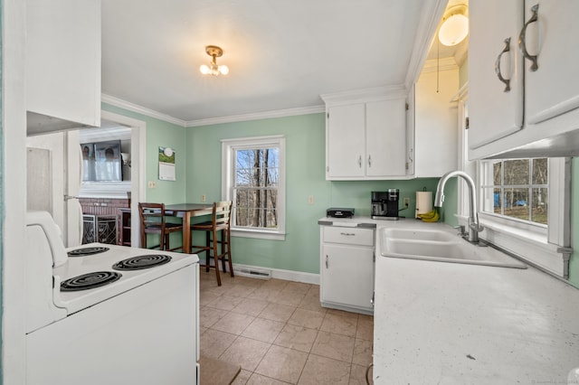 kitchen featuring sink, white cabinetry, white range with electric cooktop, and light tile floors