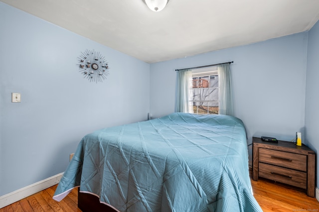 bedroom with hardwood / wood-style flooring