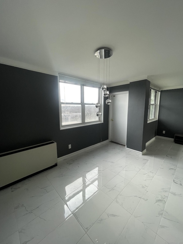 empty room with a wealth of natural light and crown molding