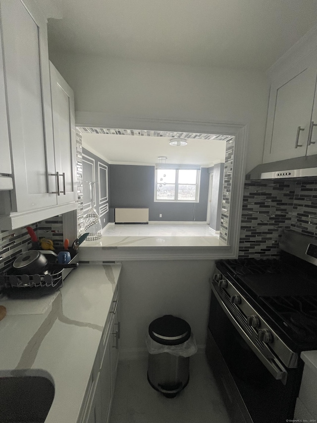 kitchen featuring decorative backsplash, white cabinetry, exhaust hood, and black gas range oven