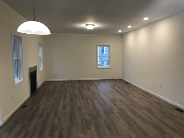 spare room with dark wood-type flooring