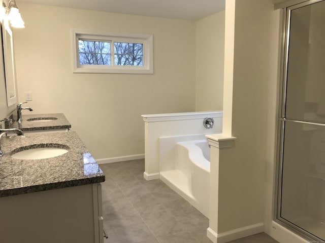 bathroom featuring vanity and shower with separate bathtub