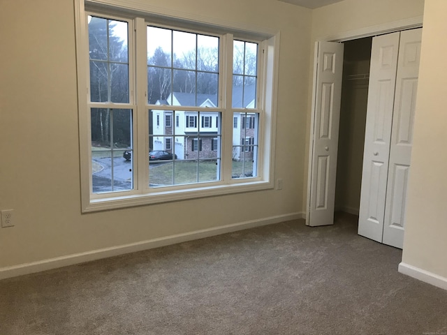 unfurnished bedroom featuring carpet and a closet