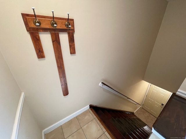 stairway with tile patterned flooring