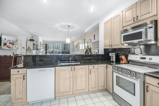 kitchen featuring electric range oven, light brown cabinetry, light tile floors, sink, and dishwasher