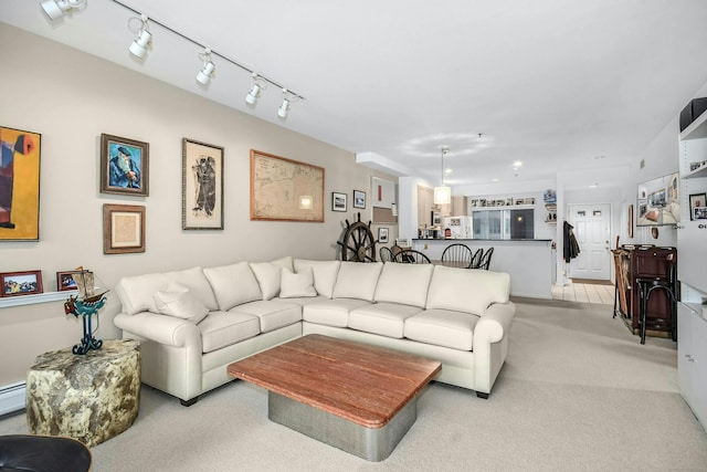 living room with light carpet and track lighting