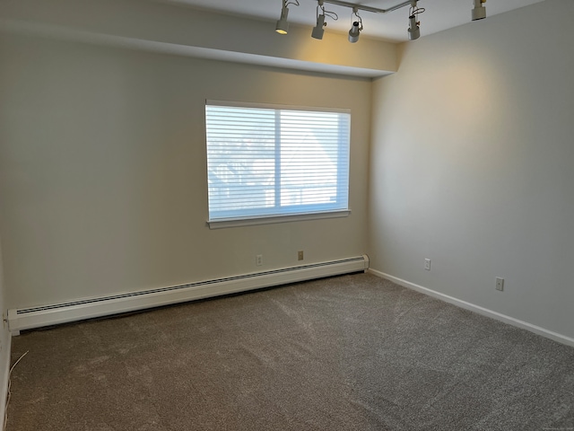 carpeted empty room with rail lighting and baseboard heating