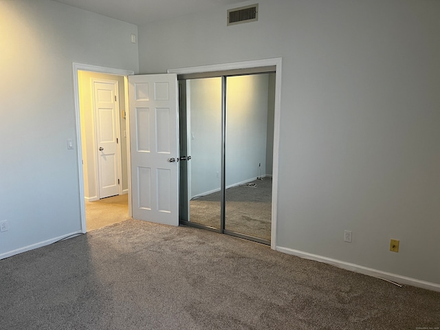 unfurnished bedroom with carpet and a closet