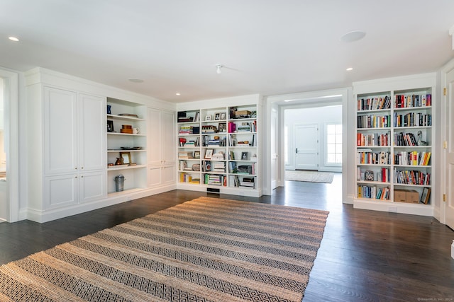 interior space with built in shelves and dark wood-type flooring