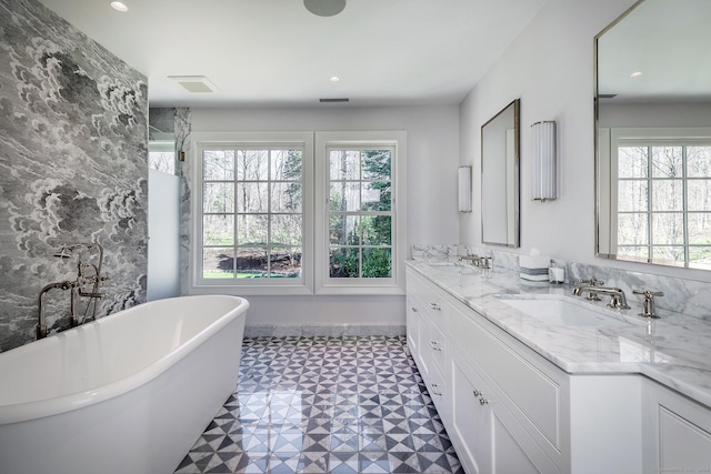 bathroom with vanity and a tub