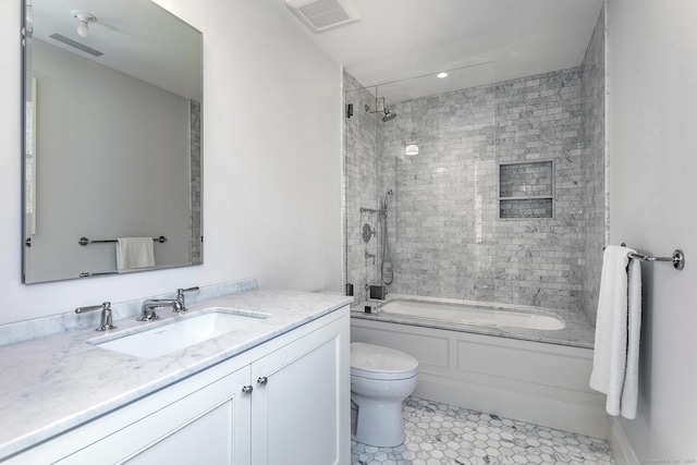 full bathroom with tiled shower / bath combo, vanity, tile patterned flooring, and toilet