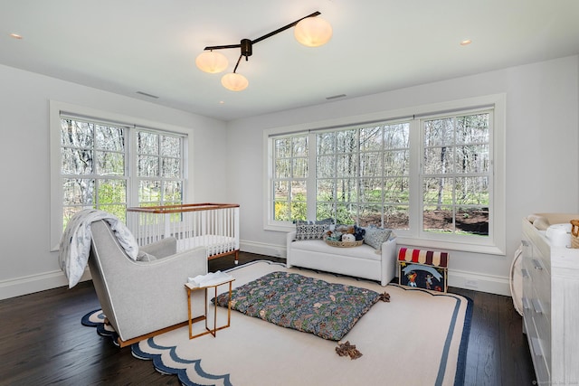 sitting room with dark hardwood / wood-style floors and a healthy amount of sunlight