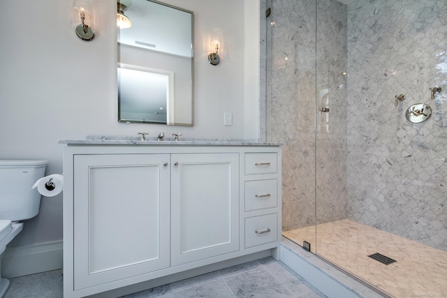 bathroom with vanity, an enclosed shower, and toilet