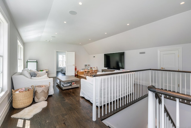 living room with dark wood-type flooring and lofted ceiling