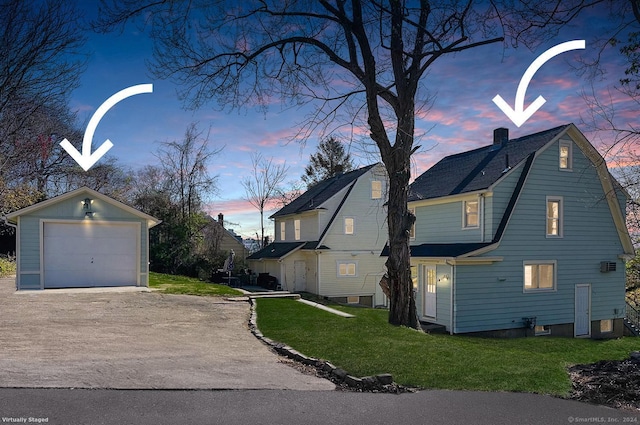 property exterior at dusk featuring a garage, an outdoor structure, and a lawn