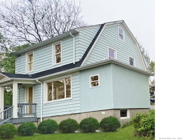 view of property exterior with a lawn