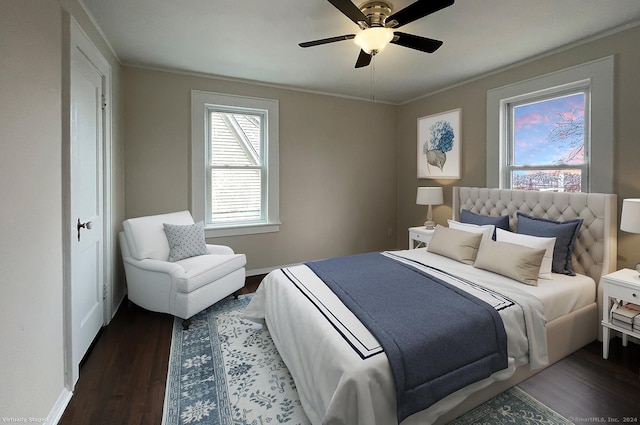 bedroom featuring dark hardwood / wood-style floors, multiple windows, crown molding, and ceiling fan