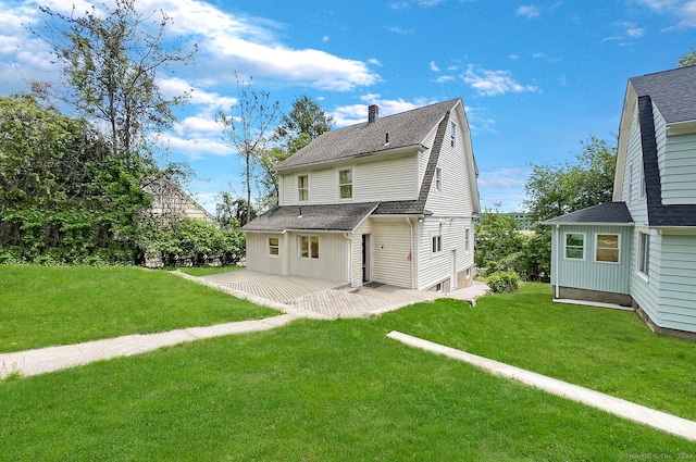 rear view of property featuring a patio area and a lawn