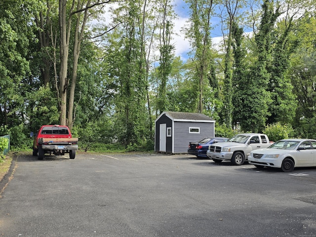 73 Bliss St, East Hartford, CT 06108 - uncovered parking lot featuring a storage unit