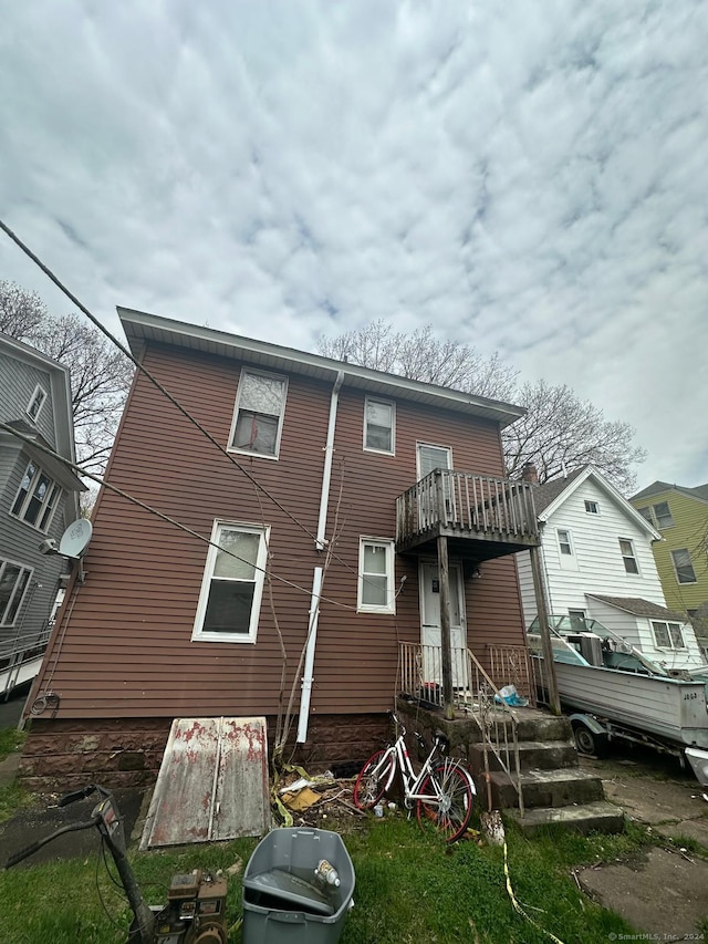 rear view of property featuring a balcony