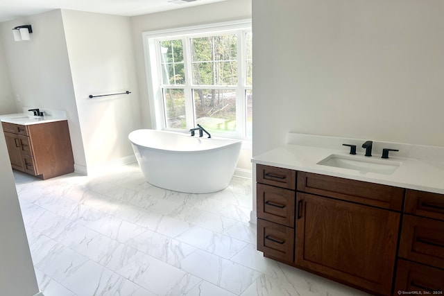 bathroom with a washtub and vanity