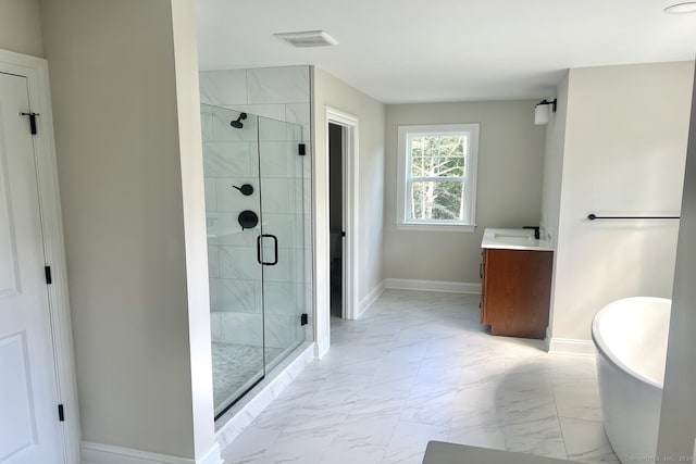 bathroom with vanity and shower with separate bathtub