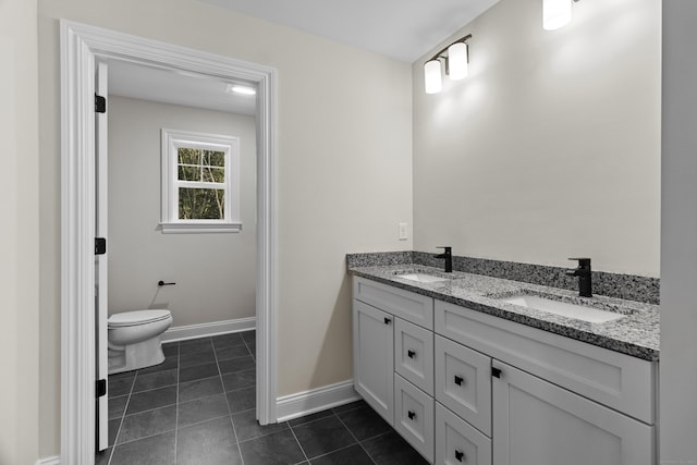 bathroom with tile patterned flooring, a sink, toilet, and double vanity