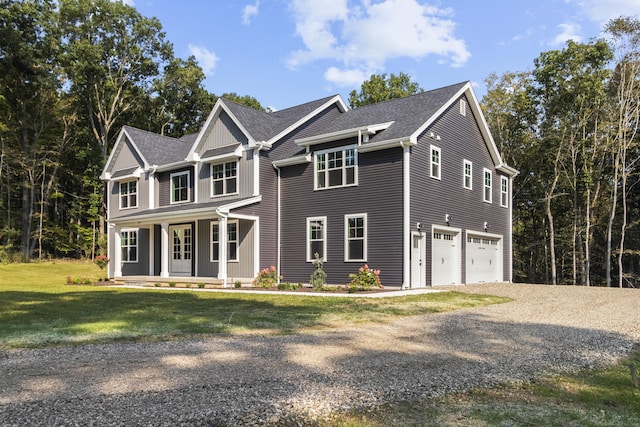 view of front of house with gravel driveway, a porch, a shingled roof, an attached garage, and a front yard