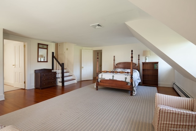 bedroom featuring a baseboard radiator and dark hardwood / wood-style floors