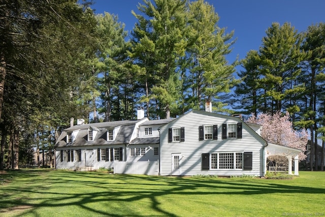 back of property featuring a lawn