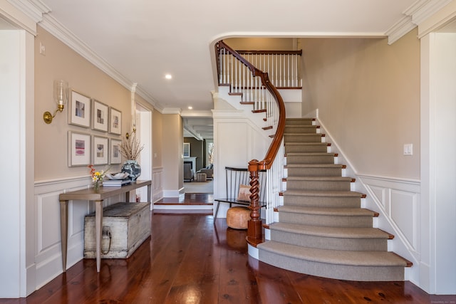 stairway featuring crown molding and dark hardwood / wood-style floors