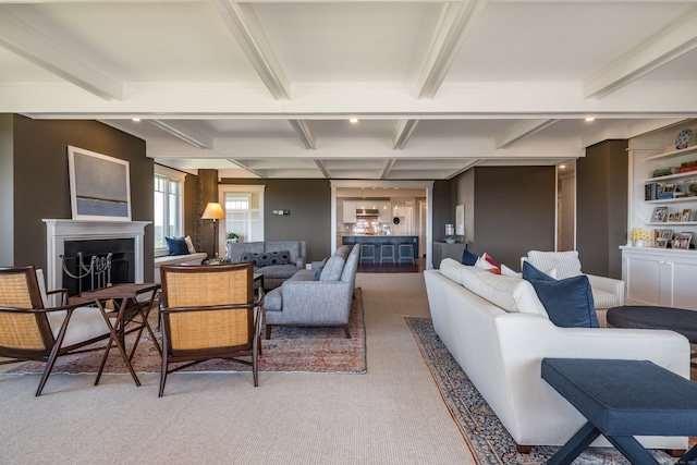 carpeted living room featuring beamed ceiling