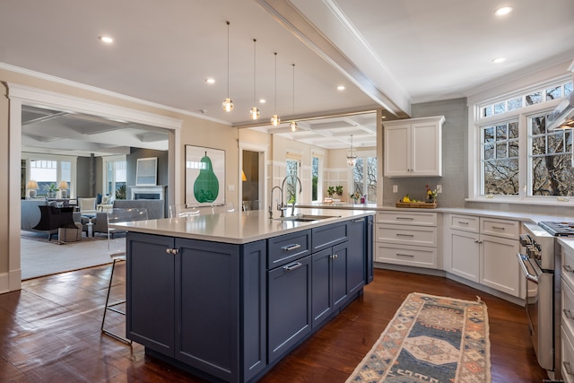 kitchen with white cabinetry, beamed ceiling, a center island with sink, stainless steel range, and dark wood-type flooring