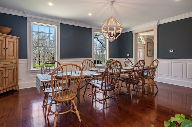 dining room featuring an inviting chandelier, crown molding, and dark hardwood / wood-style floors