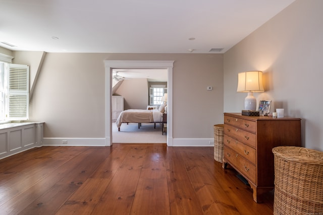 bedroom with dark wood-type flooring