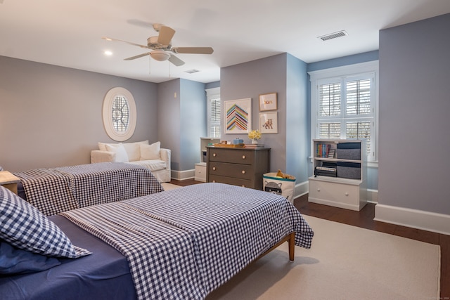 bedroom with dark wood-type flooring and ceiling fan