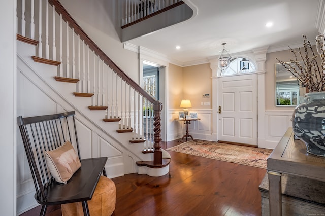 foyer with hardwood / wood-style flooring and ornamental molding