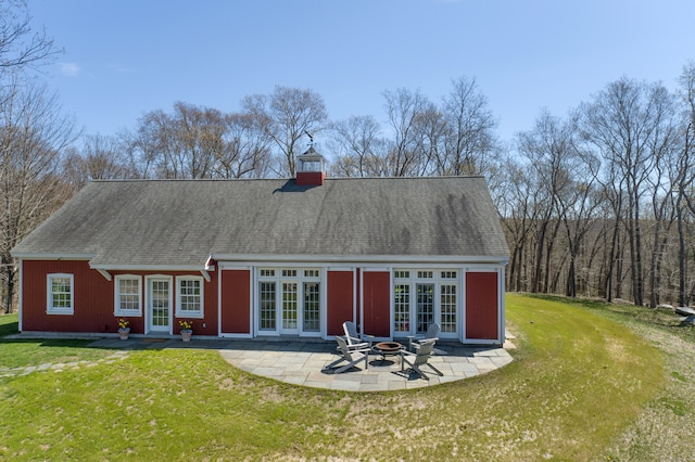 back of property featuring french doors, a yard, and a patio area