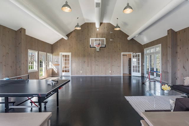 rec room featuring beamed ceiling, wooden walls, french doors, high vaulted ceiling, and dark wood-type flooring