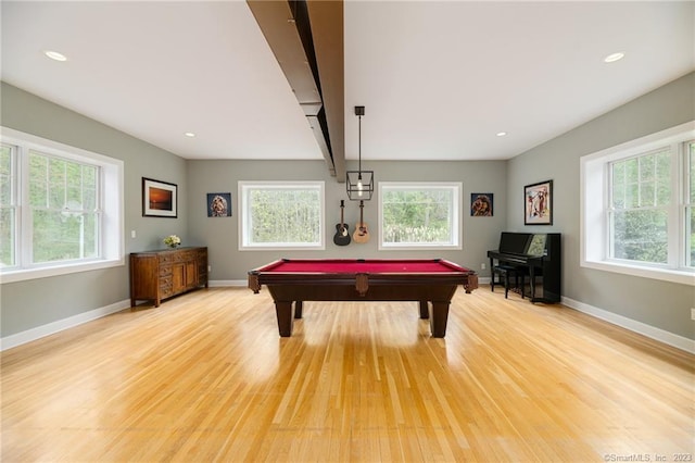 playroom featuring light wood-type flooring and a healthy amount of sunlight