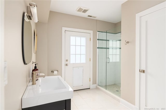 full bath with a sink, visible vents, a stall shower, and tile patterned floors