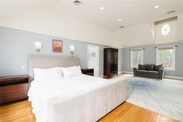 bedroom featuring vaulted ceiling, recessed lighting, visible vents, and light wood finished floors