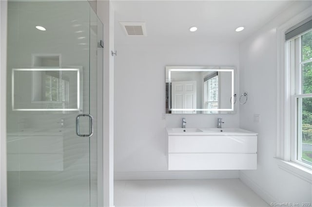 bathroom with visible vents, a sink, recessed lighting, a shower stall, and baseboards