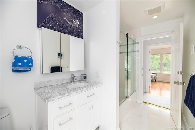 full bathroom with visible vents, baseboards, toilet, marble finish floor, and vanity