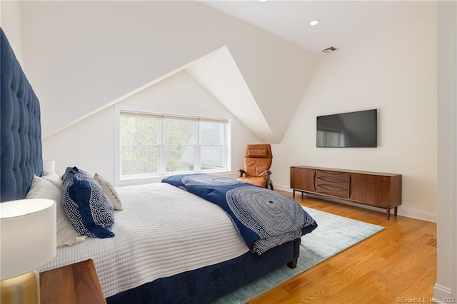 bedroom with visible vents, baseboards, lofted ceiling, recessed lighting, and wood finished floors