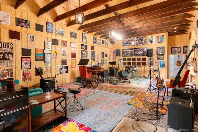 home office with beamed ceiling and wood walls