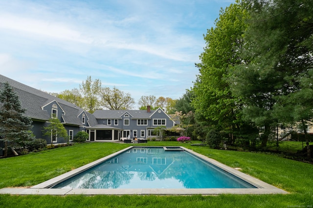 outdoor pool with a yard