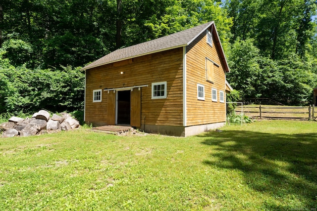 view of outbuilding featuring a yard