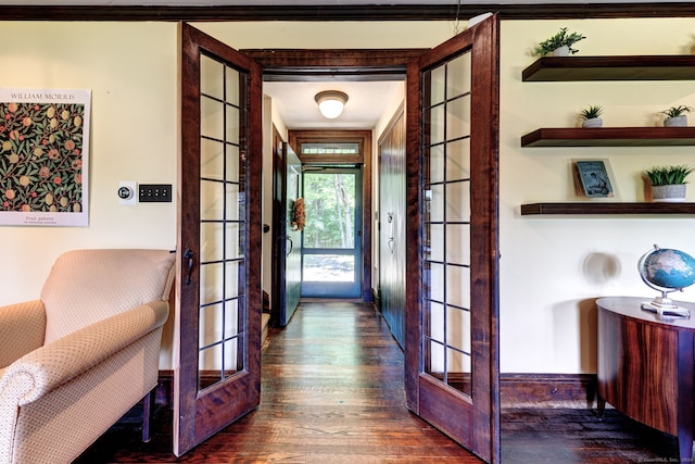 interior space with dark hardwood / wood-style flooring, french doors, and crown molding